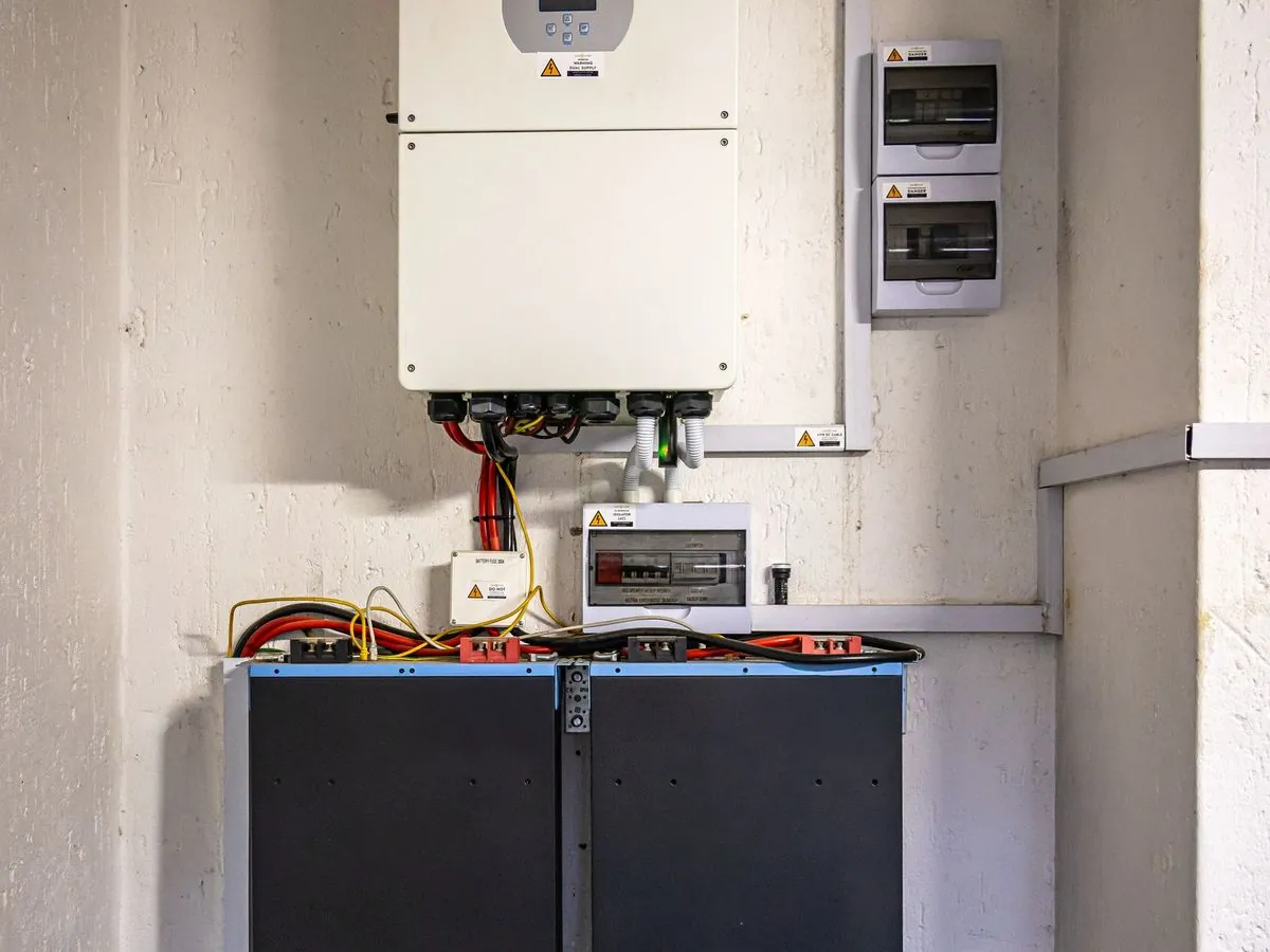 Home battery backup system: an inverter wired to stacked battery modules