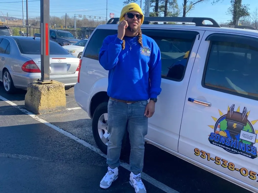 Brandon Hamilton, founder of Sonshines Sovereign Solutions, next to a company vehicle