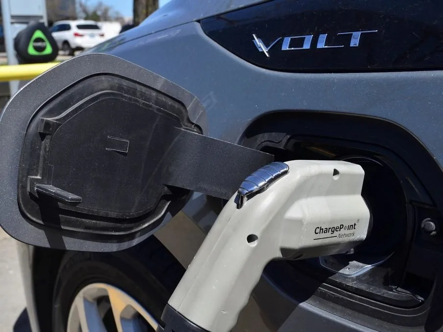 Electric vehicle plugged into a charging station